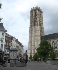 Mechelen Cathedral and the statue of Margaret Of Austria.