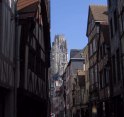 St. Ouen rises above a lane of timber houses